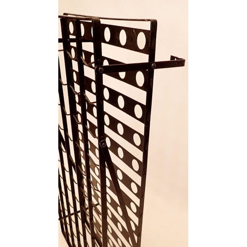 1018 - A Victorian wrought iron wall mounted bottle rack with gridwork for seventy eight bottles of wine, w... 