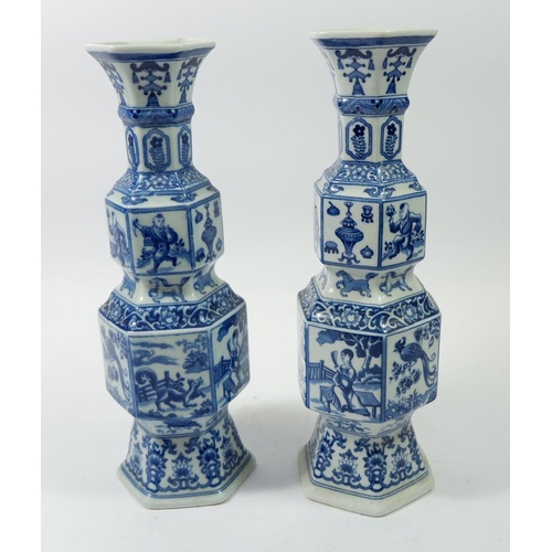 104 - A pair of Chinese blue and white hexagonal vases with panelled decoration, 31cm tall