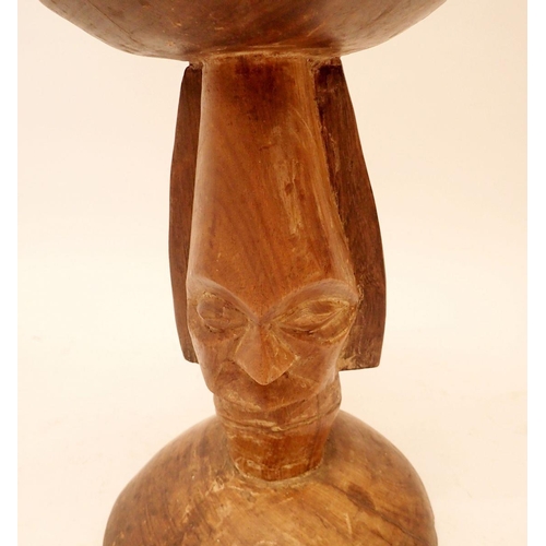 1052 - A carved African stool with head form support, 40cm tall