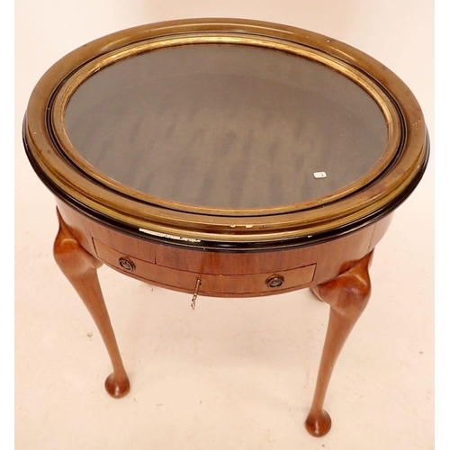 1057 - A Victorian mahogany oval vitrine table with rise top, all raised on cabriole supports