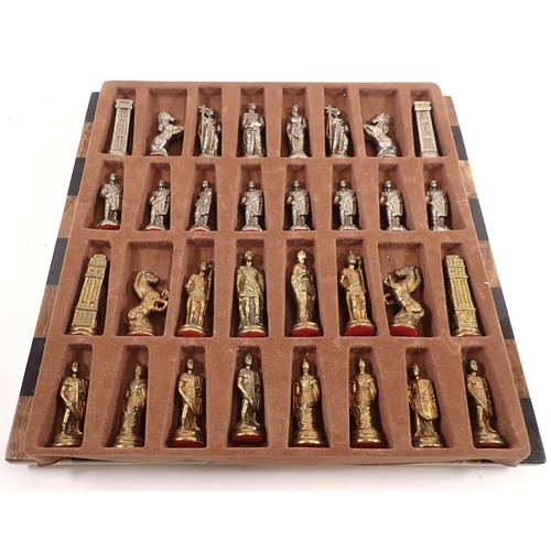 1194 - A metal figurative chess set with knights and horses and 'marble' chess board