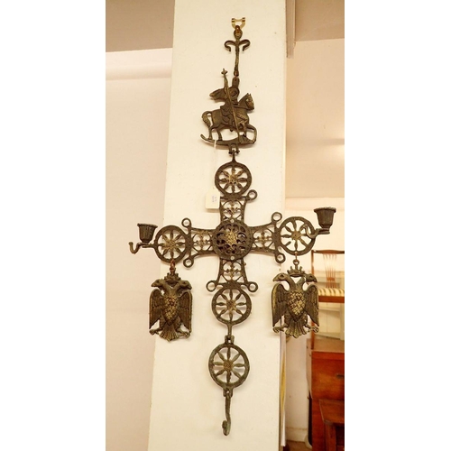 1280 - A Byzantine style cast metal church candle holder, 50cm high