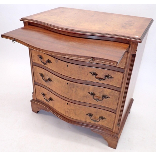 1285 - A reproduction walnut bachelors chest with serpentine front and brushing slide, 71cm wide