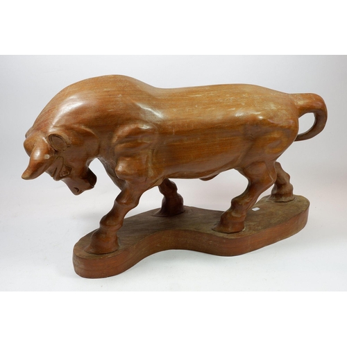 1286 - A large carved wooden bull, 59cm long