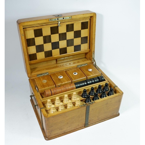 1298 - A Victorian light oak games compendium including chess set, draughts, board, 'Nine Mens Morris' and ... 