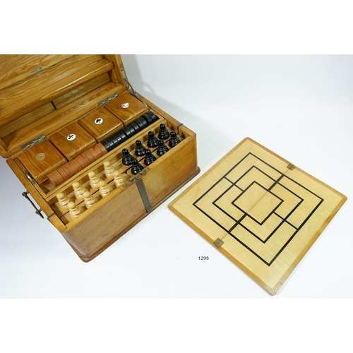 1298 - A Victorian light oak games compendium including chess set, draughts, board, 'Nine Mens Morris' and ... 