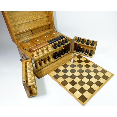 1298 - A Victorian light oak games compendium including chess set, draughts, board, 'Nine Mens Morris' and ... 