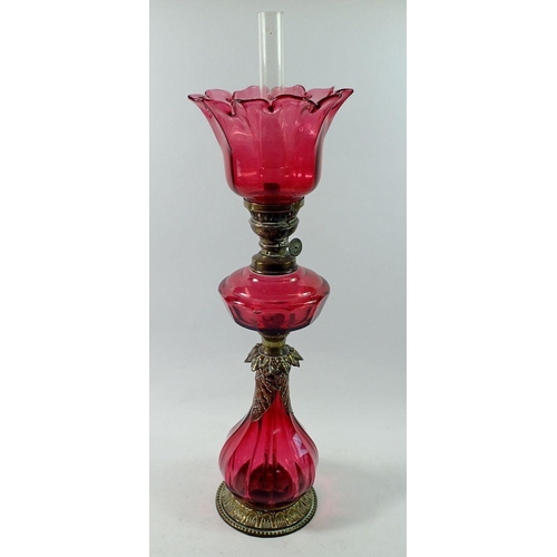 1314 - A Victorian silver plated on copper oil lamp with cranberry glass base, reservoir and shade, 54cm