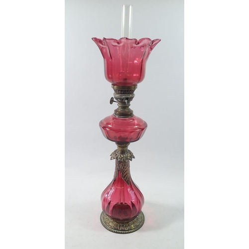 1314 - A Victorian silver plated on copper oil lamp with cranberry glass base, reservoir and shade, 54cm