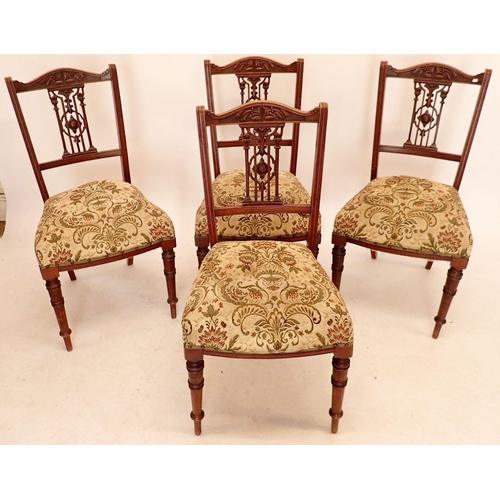 1332 - A set of four Edwardian mahogany side chairs with carved decorative backs