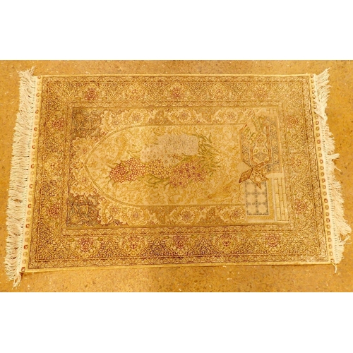 1334 - A small Persian silk prayer rug in cream and gold colours decorated birds and flowers 95 x 63cm