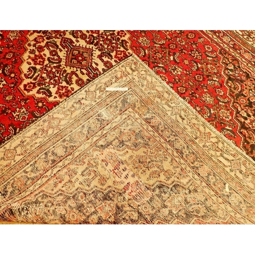 1349A - A Persian Mashad carpet with rich red ground and vintage traditional floral medallions 329 x 219cm -... 