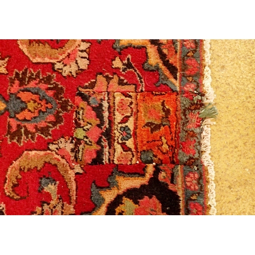 1360 - A large Persian Sarouk carpet with red ground and traditional floral pattern - repaired, 291 x 206cm... 