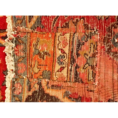 1360 - A large Persian Sarouk carpet with red ground and traditional floral pattern - repaired, 291 x 206cm... 