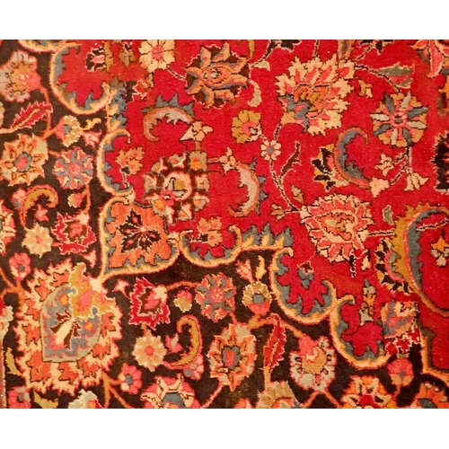 1360 - A large Persian Sarouk carpet with red ground and traditional floral pattern - repaired, 291 x 206cm... 