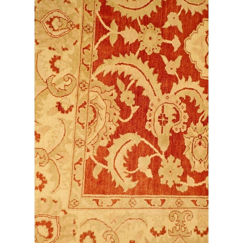 1362 - A floral Persian rug with cream and pale green foliage decoration on coral red ground, 226 x 170cm, ... 