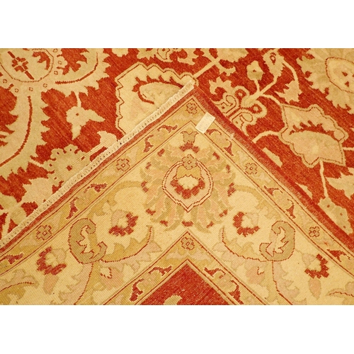 1362 - A floral Persian rug with cream and pale green foliage decoration on coral red ground, 226 x 170cm, ... 