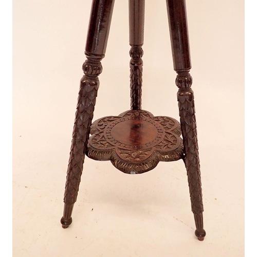 1381 - A Victorian carved and lobed Indian style two tier occasional table, 42cm diameter