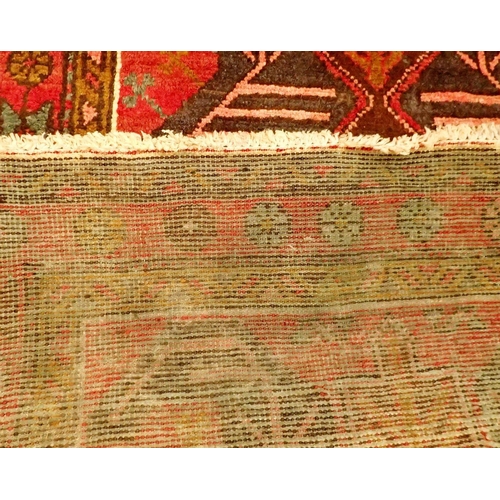 1395 - A Perian Heriz runner with rich red ground and unique medallion pattern 310 x 98cm