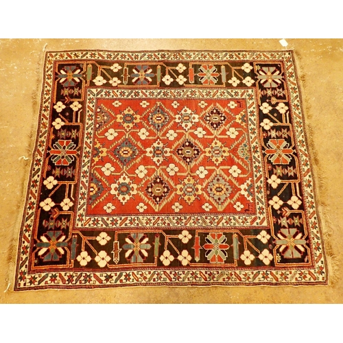 1400 - A Turkoman antique rug with stylised floral motifs on a madder ground and blue floral borders, 130 x... 