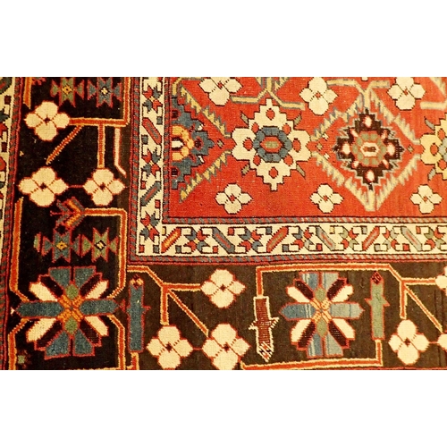 1400 - A Turkoman antique rug with stylised floral motifs on a madder ground and blue floral borders, 130 x... 