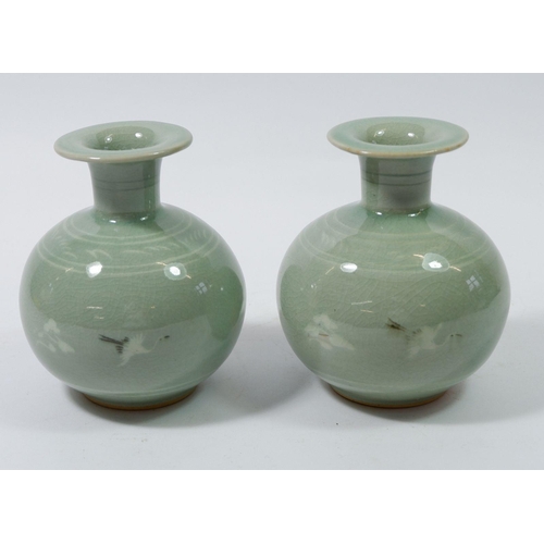 151 - A pair of Korean celadon bulbous vases with stork decoration and signed to base, 12cm