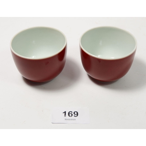 169 - A Chinese Imperial style pair of monochrome underglaze red teacups, 5cm tall