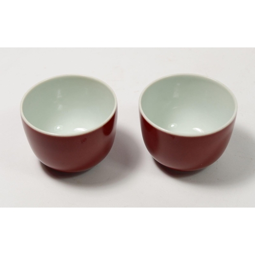 169 - A Chinese Imperial style pair of monochrome underglaze red teacups, 5cm tall