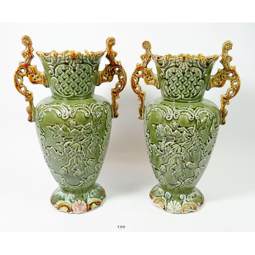 190 - A pair of Victorian large two handled Majolica style vases with floral decoration, 34cm