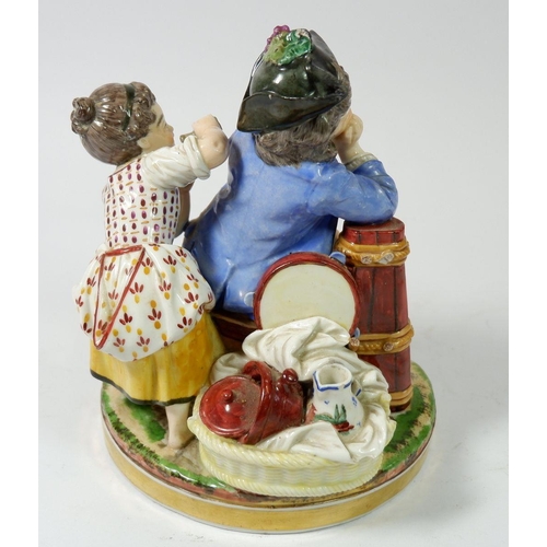 205 - A 19th century porcelain group of young girl surprising sleeping boy, 18cm