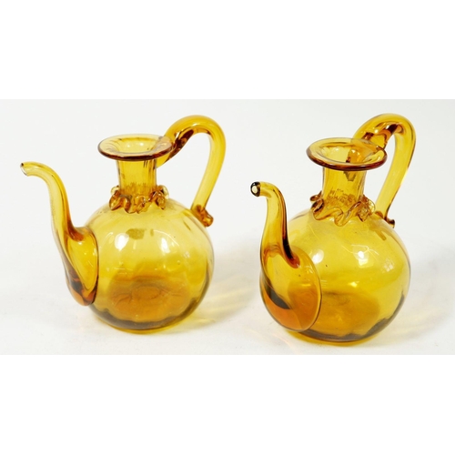 229 - A pair of 19th century Spanish amber glass oil flasks, 10cm