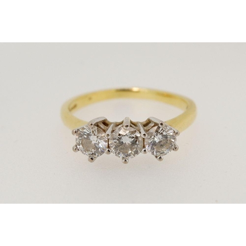 439 - An 18 carat gold three stone diamond ring, size Q, 4.2g (total diamond weight 1 carat)