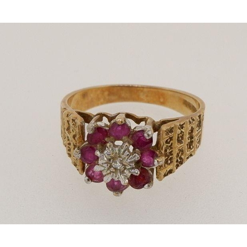 451 - A 9 carat gold ring set chip diamond and red stones on textured shoulders, 3.6g, size O