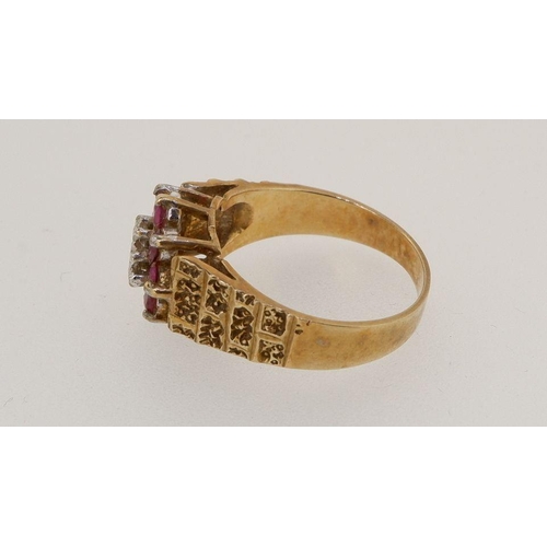 451 - A 9 carat gold ring set chip diamond and red stones on textured shoulders, 3.6g, size O