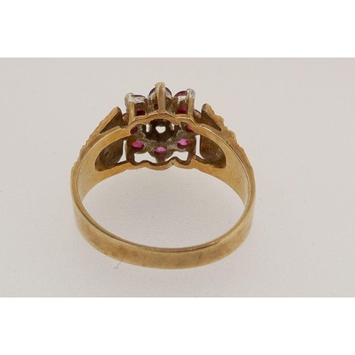 451 - A 9 carat gold ring set chip diamond and red stones on textured shoulders, 3.6g, size O