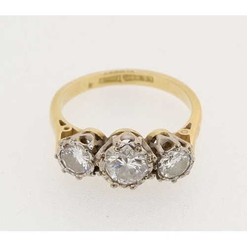 463 - An 18 carat gold and platinum three stone diamond ring with illusion settings, the centre stone 4.8m... 