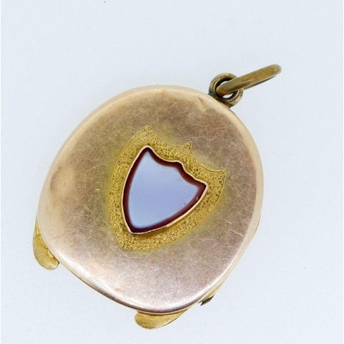 484 - A Victorian gold horseshoe form locket inset cameo cut stone shield, 7.4g unmarked but tested as gol... 