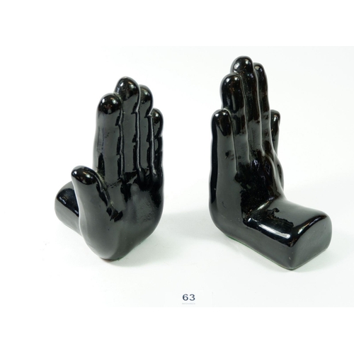 63 - A pair of 'black hand' novelty black hand book ends, 16cm tall