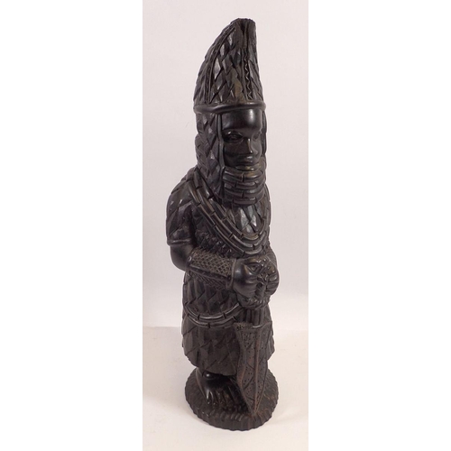 776 - A carved African figure with a spear, 38cm