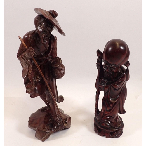 777 - Two Oriental carved wooden figures, largest 26cm