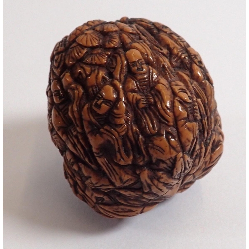 803 - A Japanese Meiji period walnut carved with a thousand faces