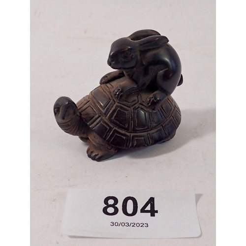 804 - A Japanese carved hardwood netsuke with hare riding a tortoise