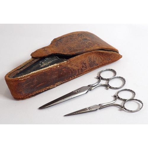 809 - A Victorian leather scissor case and two pairs of steel scissors