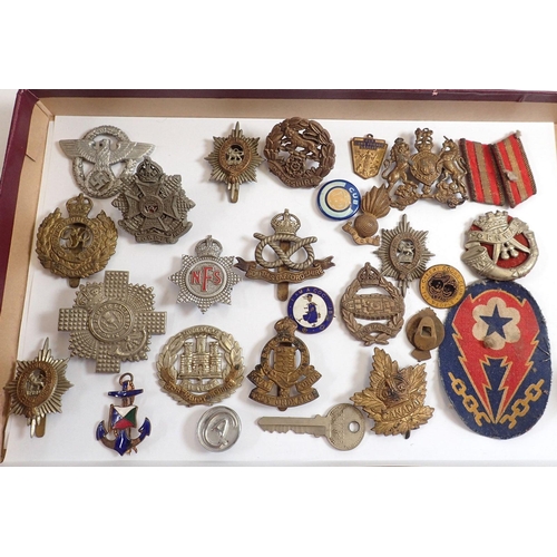 825 - A box of military badges etc.