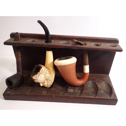 849 - Two vintage pipe racks and a selection of pipes