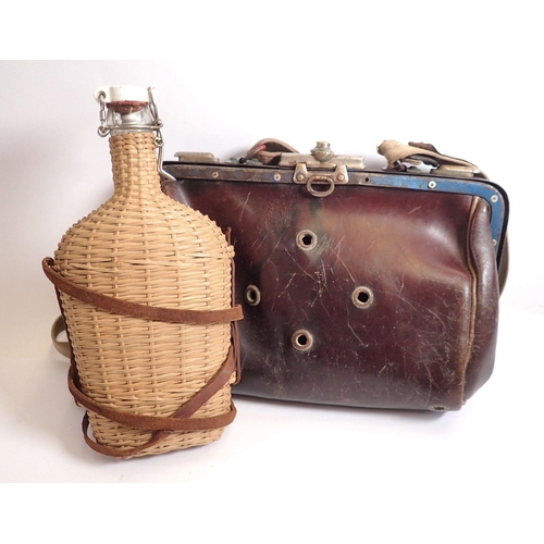 850 - A French leather hunting bag for carrying ferrets circa 1920 and a wicker clad bottle with china Lou... 