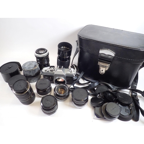 915 - A Canon camera and selection of lenses in a leather case