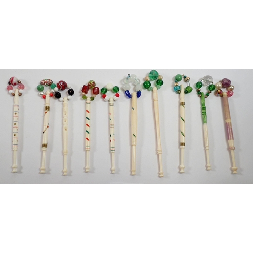 926 - A collection of nineteen antique bone bobbins with wire inlay and painted decoration