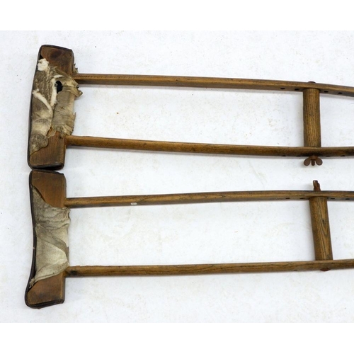 941 - A pair of wooden crutches circa 1910 by The Wantage Adjustable Crutch Company