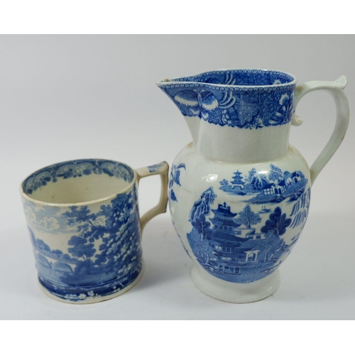 96 - A Victorian blue and white jug, 23cm tall and a large blue and white mug printed town scene (possibl... 